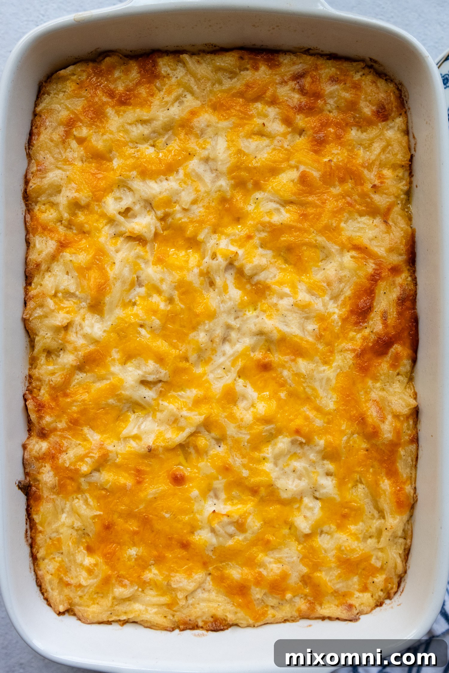 Overhead shot of casserole in a white baking dish showing all the cheese.