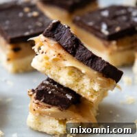 Stack of gluten free millionaire bars, showcasing layers.