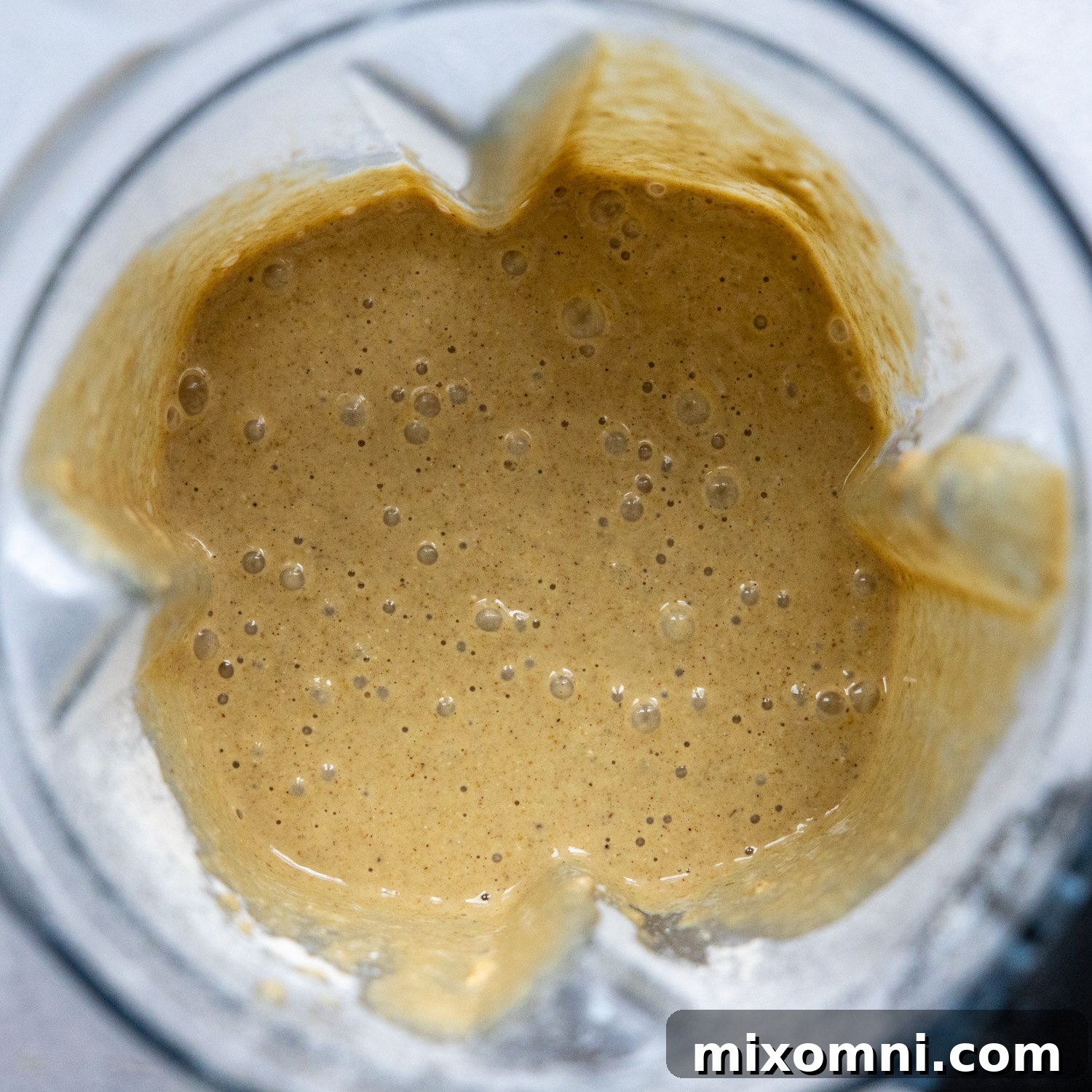 All liquid ingredients, including bananas, eggs, and milk, added to the blender with the dry ingredients for the muffin batter.