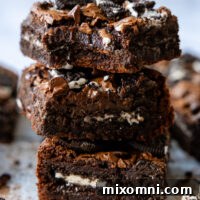 Gluten Free Oreo Brownie squares stacked on top of one another.