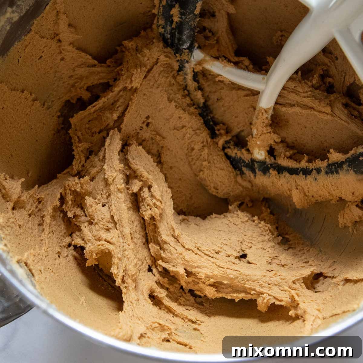 The finished gluten-free ginger snap cookie dough after all dry ingredients have been mixed in, showcasing its rich, dark consistency, ready for chilling.