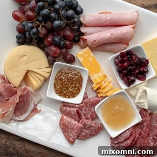 third step of how to make a charcuterie board - adding meats