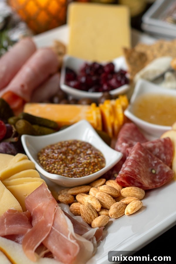 a charcuterie board close up with meats, cheeses, and nuts
