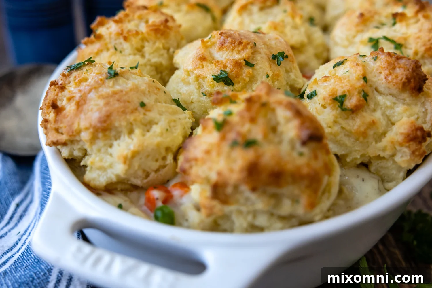 Chicken and biscuits in a white baking dish.