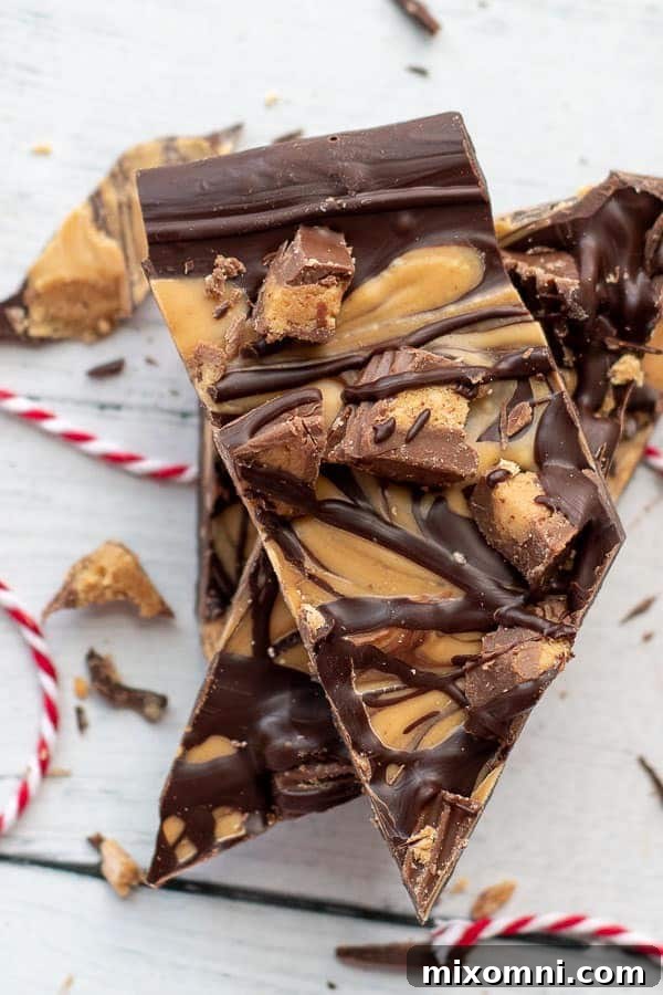 An overhead shot of glossy Tiger Butter chocolate peanut butter bark stacked up, ready to be enjoyed.