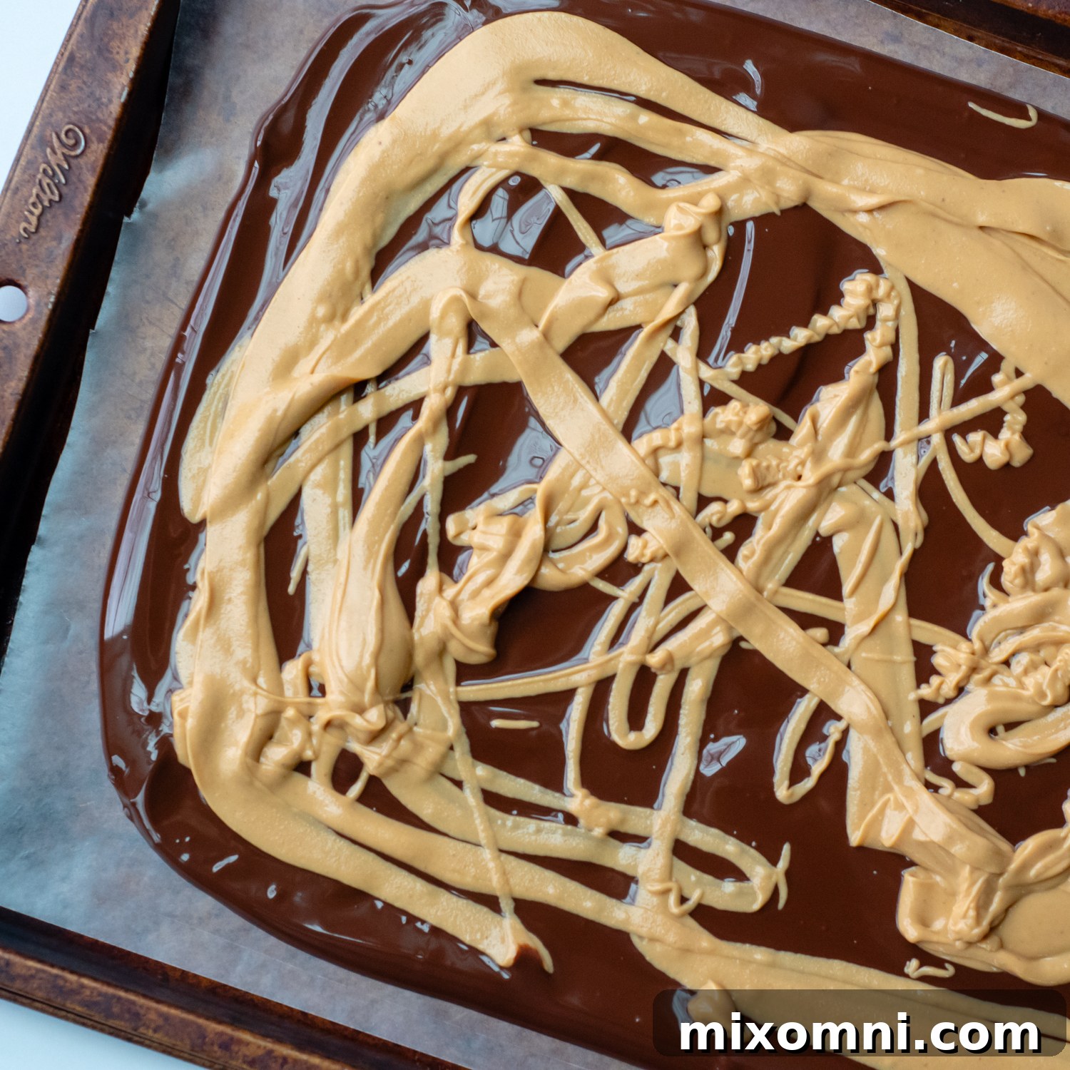 Melted peanut butter drizzled over the spread chocolate base, creating a beautiful contrast.