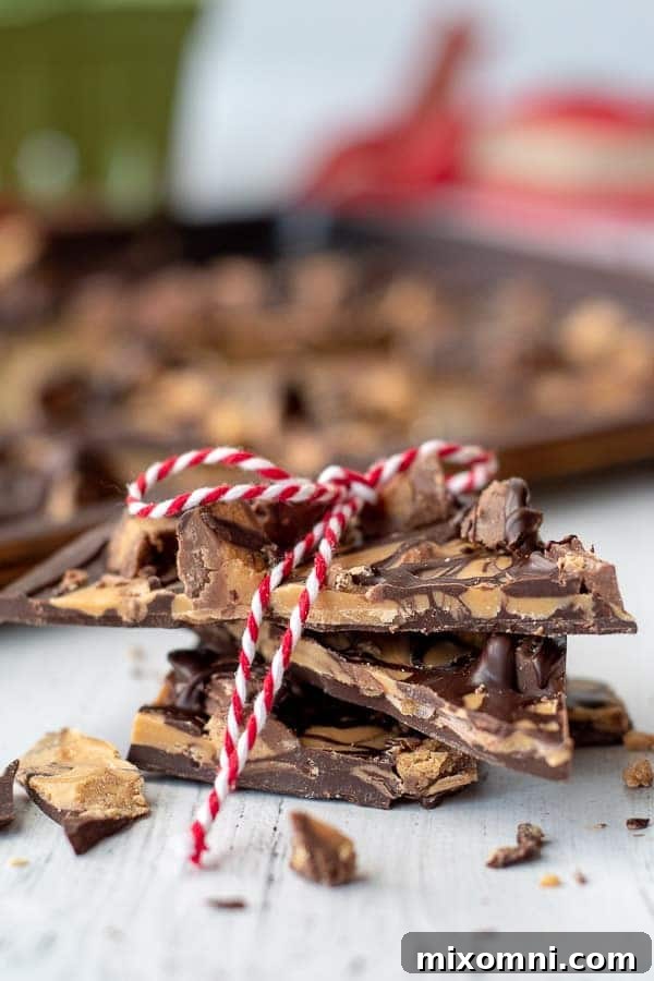 A stack of tiger butter bark with a festive red and white ribbon tied around it, perfect for gifting.