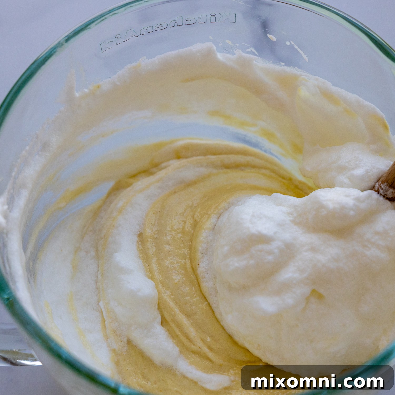 Thick cake batter in a glass bowl, just before the egg whites are folded in.