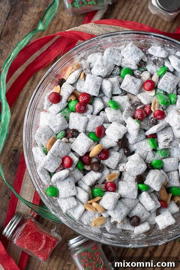 An overhead shot of Nutella puppy chow, styled in a Christmas version with ribbon and sprinkles.