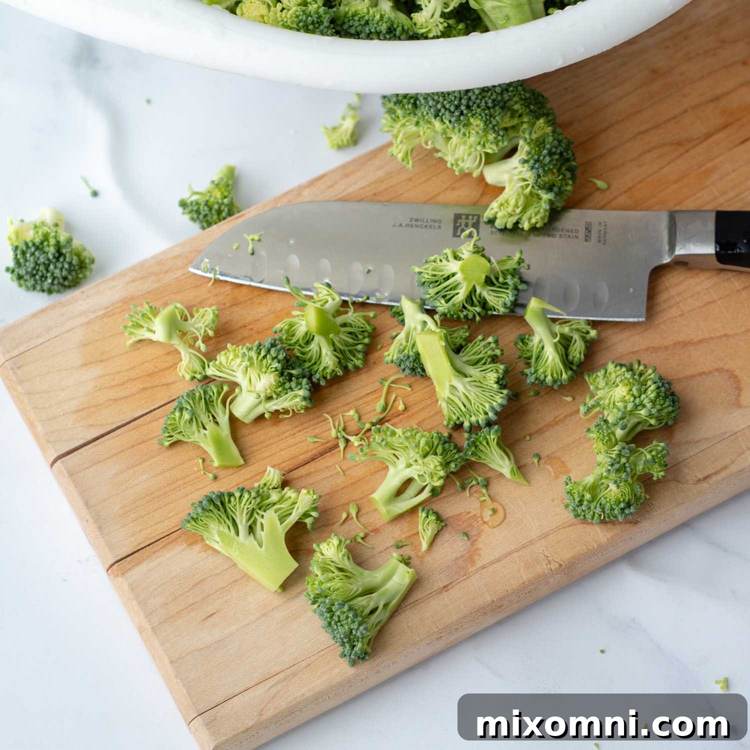 Small, uniformly cut broccoli florets on a cutting board, ready for the Instant Pot.