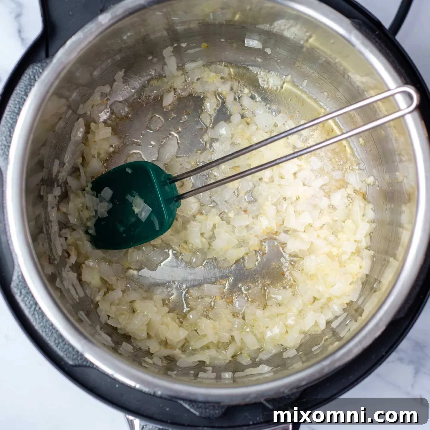 Broccoli florets, broth, salt, and pepper inside the Instant Pot before pressure cooking.