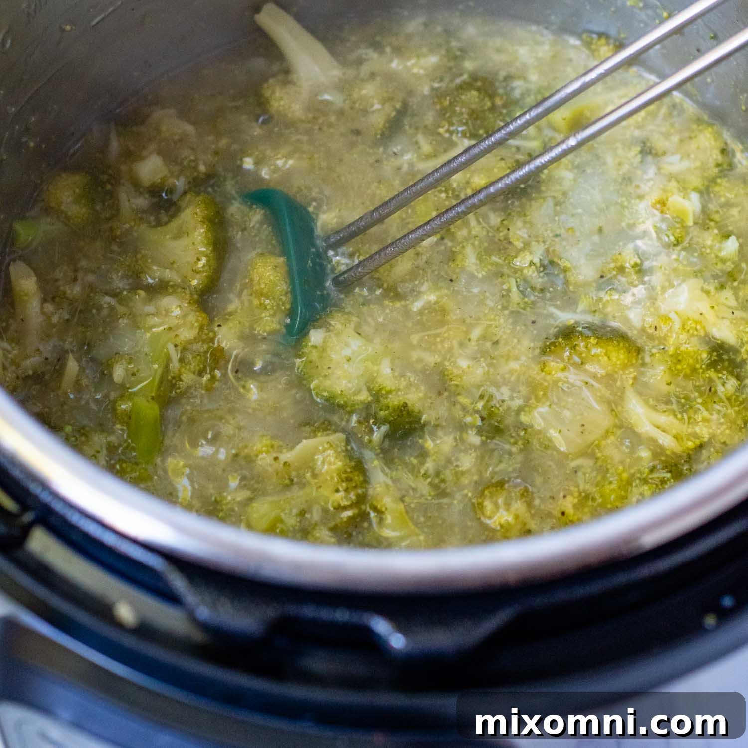 Thickened soup mixture in the Instant Pot before cheese is added, showing smooth consistency.