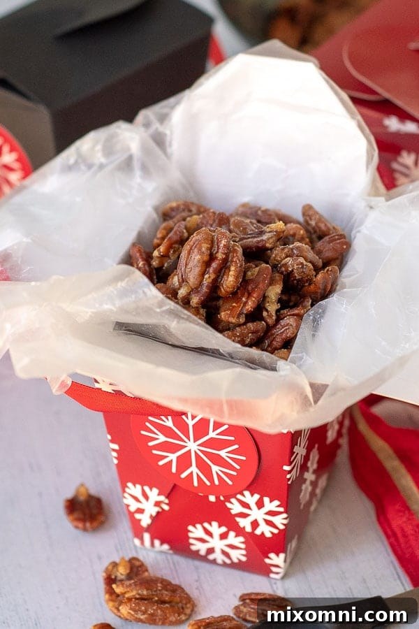 Candied pecans in a clear gift box tied with a ribbon, ready to give someone.