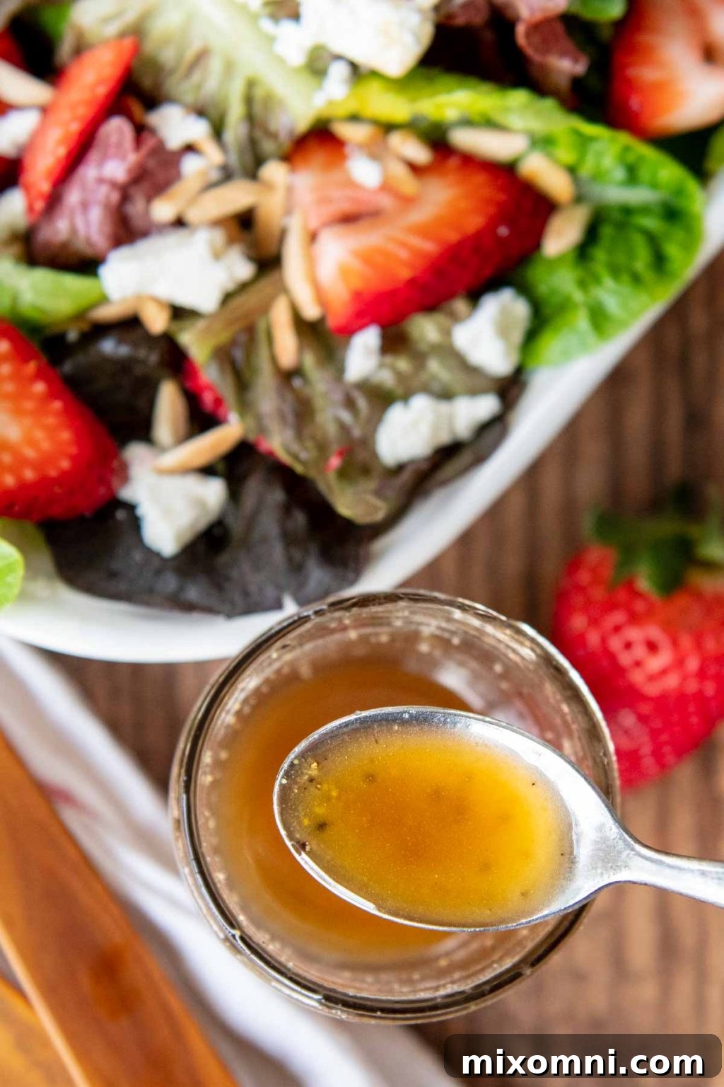 a spoon lifting dressing out of a glass jar