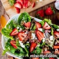 overhead shot of strawberry green salad with feta cheese on top