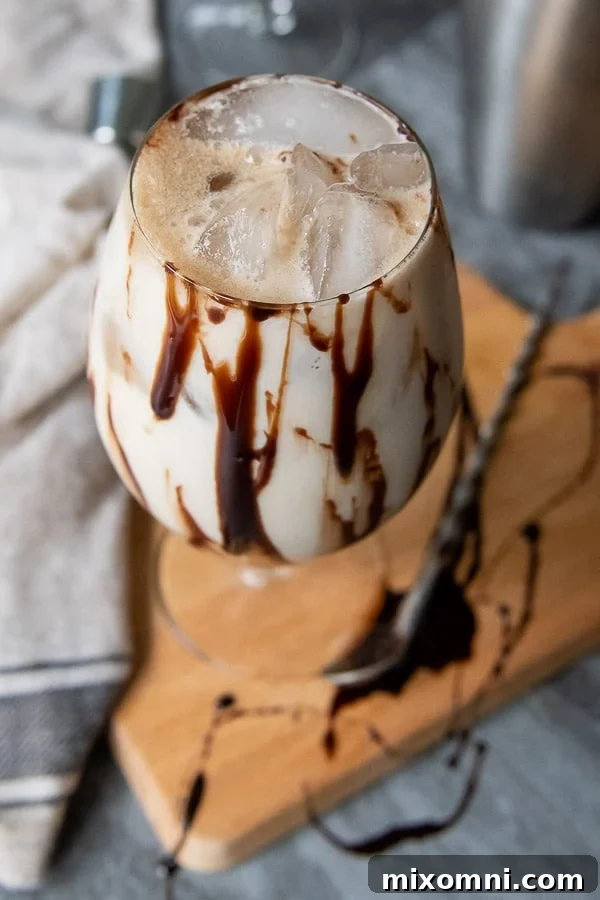 An inviting overhead shot showcasing a perfectly mixed Colorado Bulldog cocktail in a tall glass, garnished beautifully.