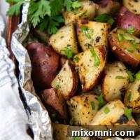 Grilled red potatoes in foil with fresh parsley.