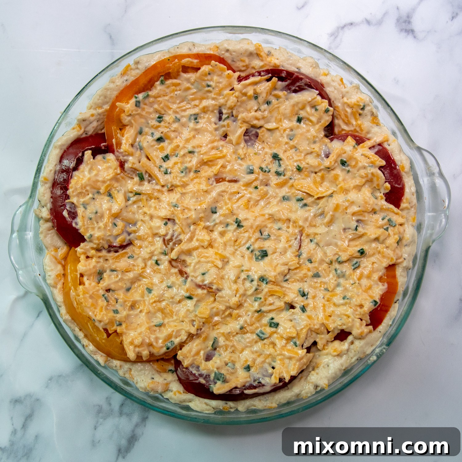 The second layer of cheese-mayo filling spread on top of the tomatoes.