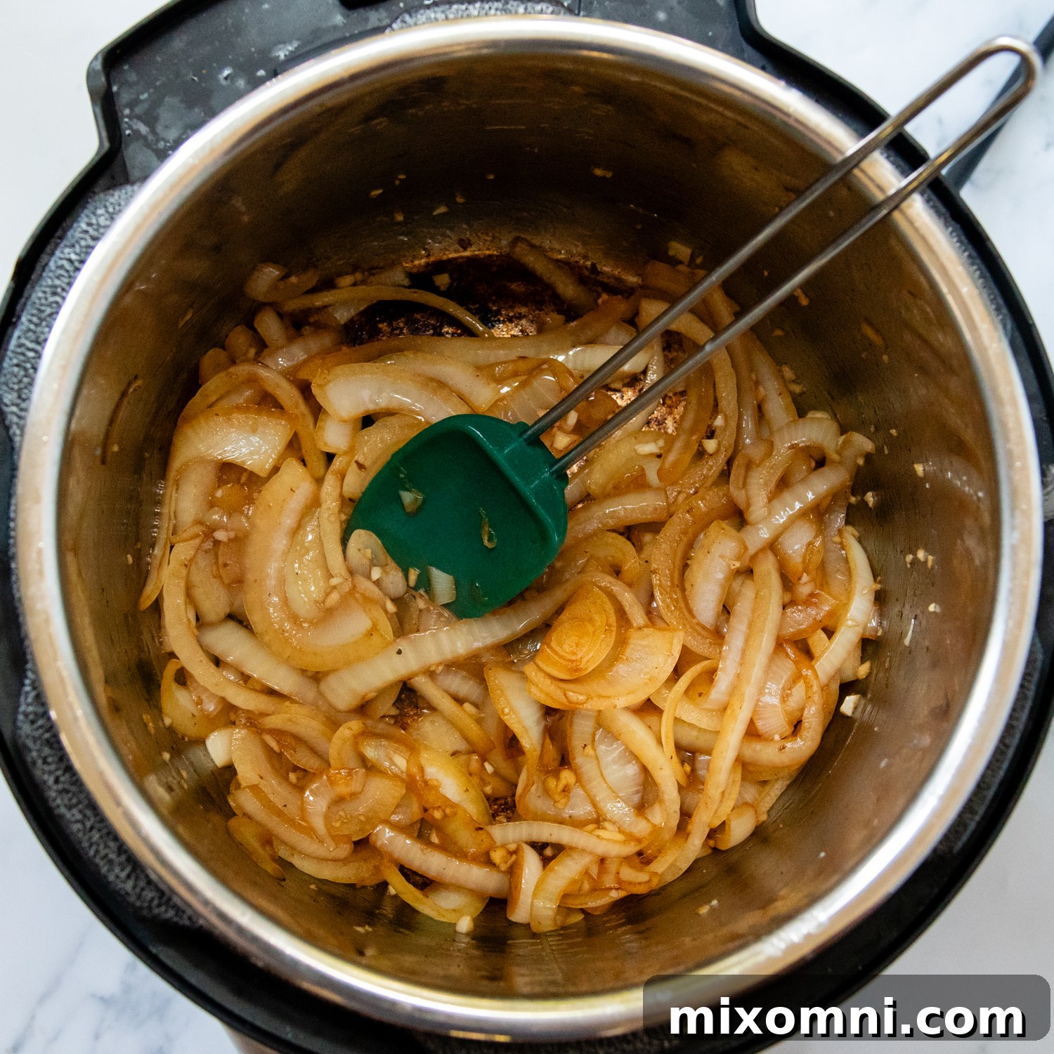 Sautéed onions and garlic cooking in a pot, demonstrating the technique for preserving texture and flavor.