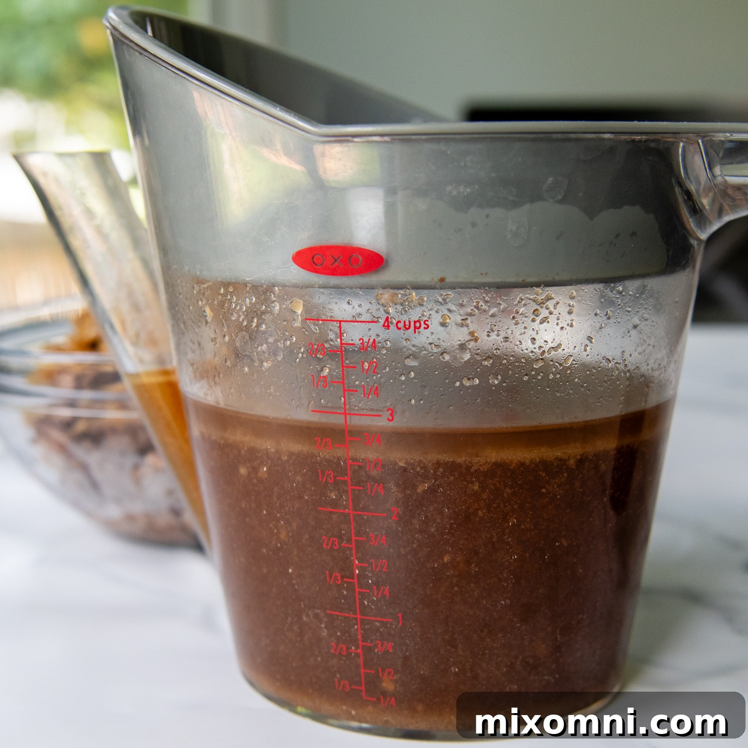 Rich, savory au jus resting in a fat separator, showcasing the clear, separated broth ready for use.
