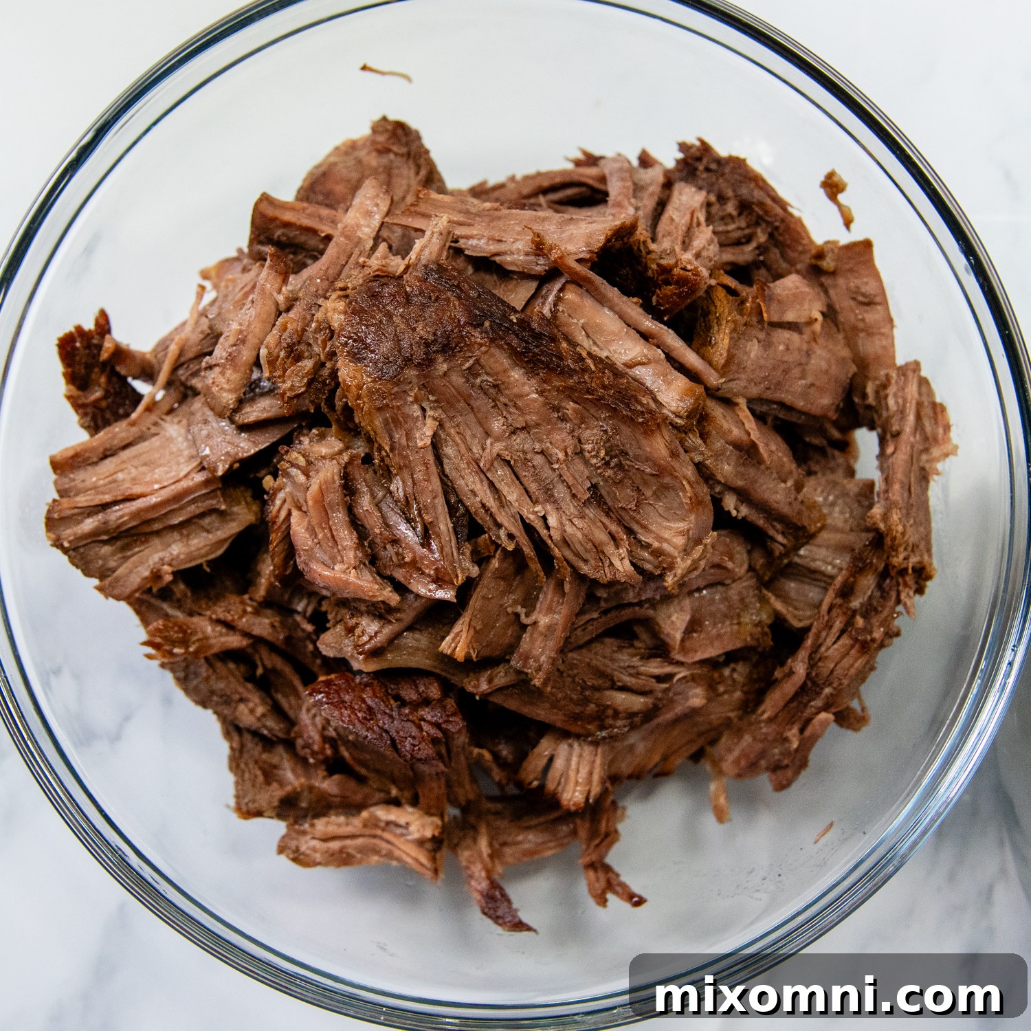 Tender, shredded beef chunks, perfectly prepared and ready to be assembled into French Dip sandwiches.