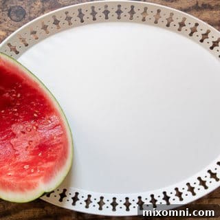 First step of how to make a dessert plate - placing a hollowed out watermelon