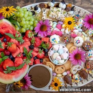A completed dessert platter with flowers decorating it