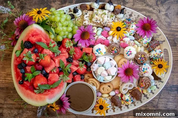 The completed dessert platter, beautifully garnished with fresh flowers, showcasing a vibrant and appealing display of sweet treats.