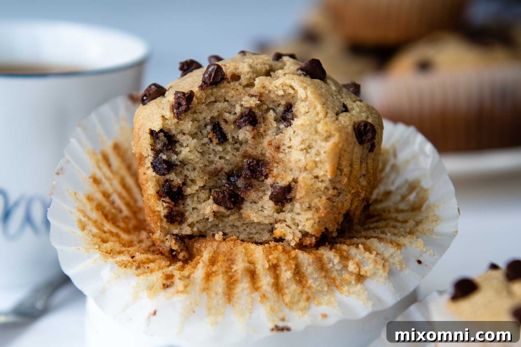 a muffin with a bite taken out facing straight on camera.