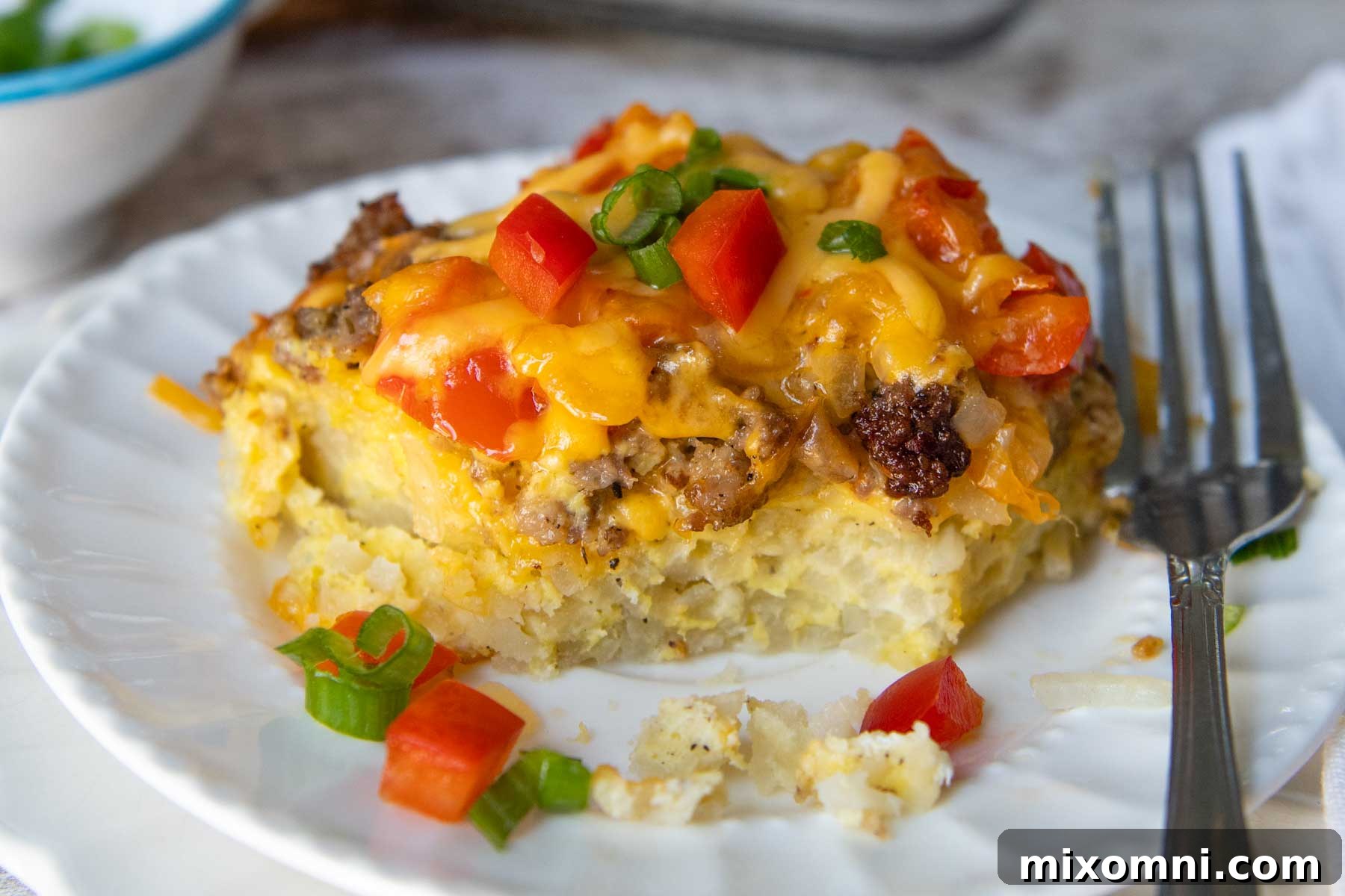 A large, fully baked gluten-free breakfast casserole, golden brown and bubbling with melted cheese, fresh out of the oven in a rectangular baking dish.