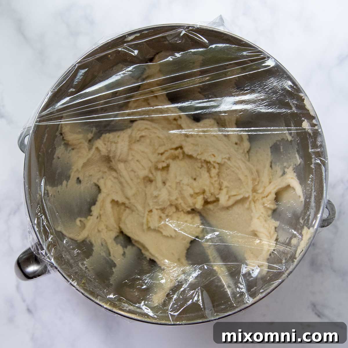 the dough with plastic wrap over the top.