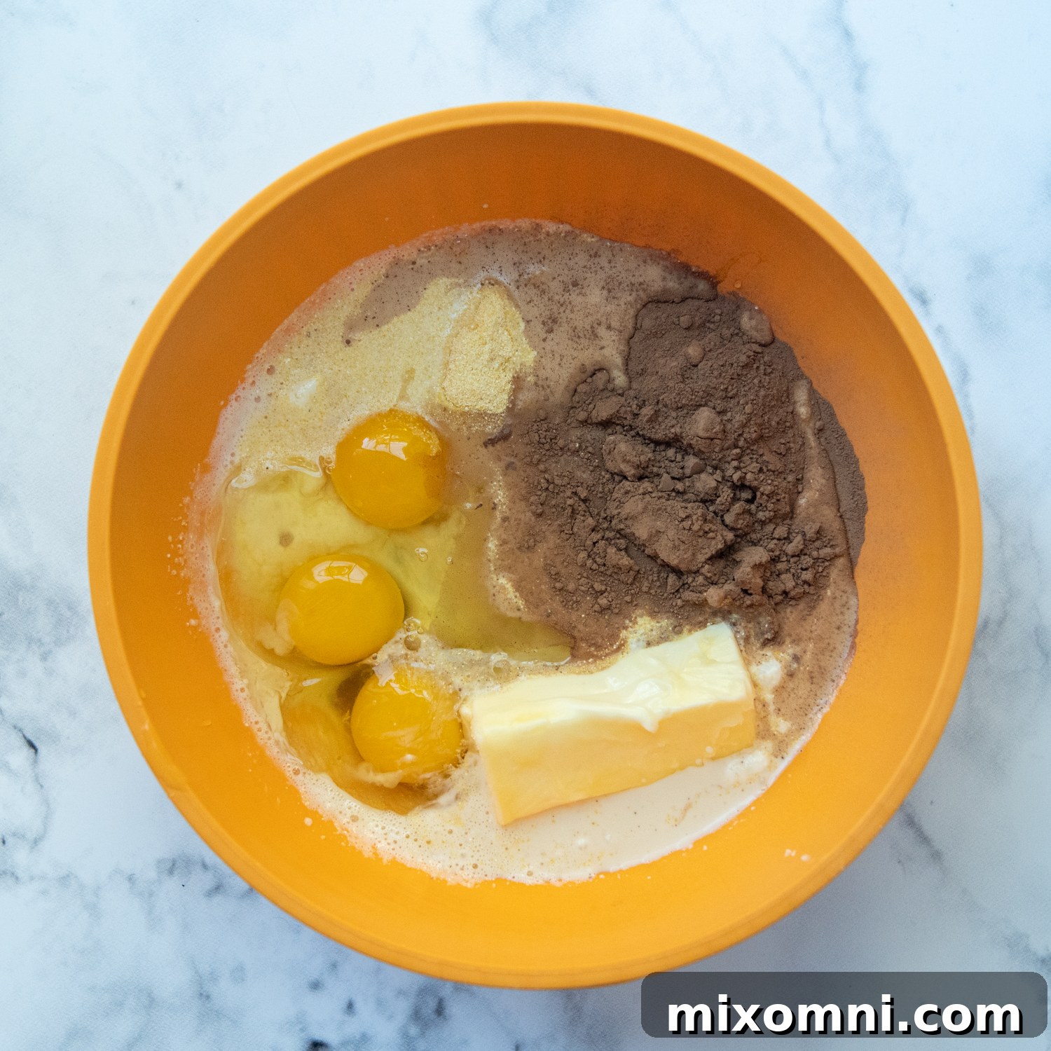 The smooth and rich chocolate filling for the pie, perfectly blended in a mixing bowl, ready to be poured.