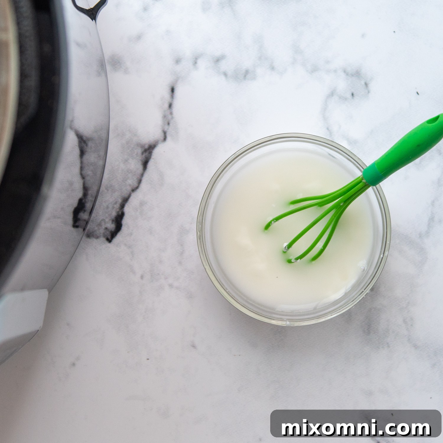 a cornstarch water slurry next to an open pressure cooker.