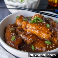 side angle shot of asian chicken thighs with chopsticks resting on side
