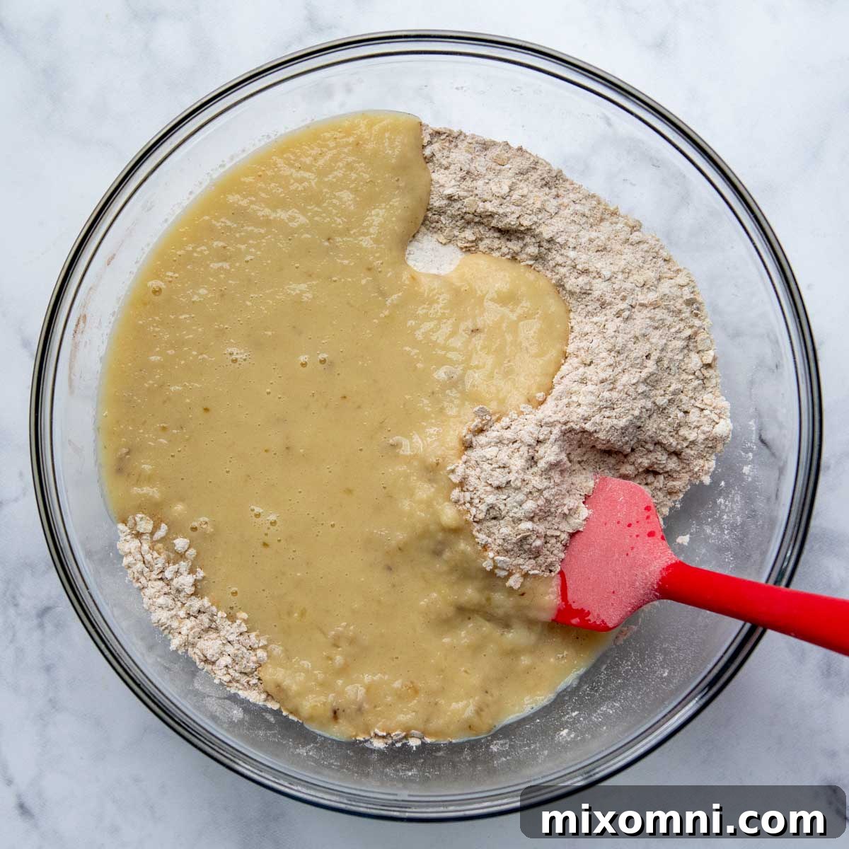 The process of gently stirring wet ingredients into the dry ingredients to form the muffin batter.
