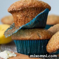 A stack of two fluffy gluten-free banana muffins with a blue muffin paper