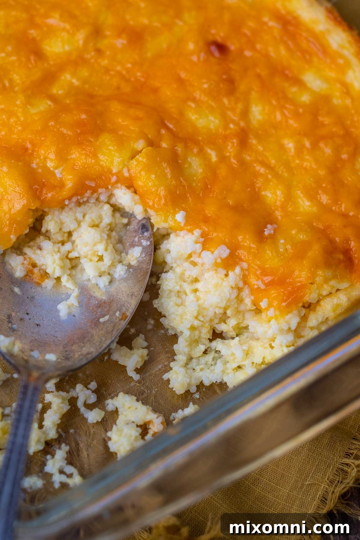 a spoon going into the glass casserole dish