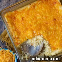 overhead shot of cheese grits casserole with shredded cheese next to it