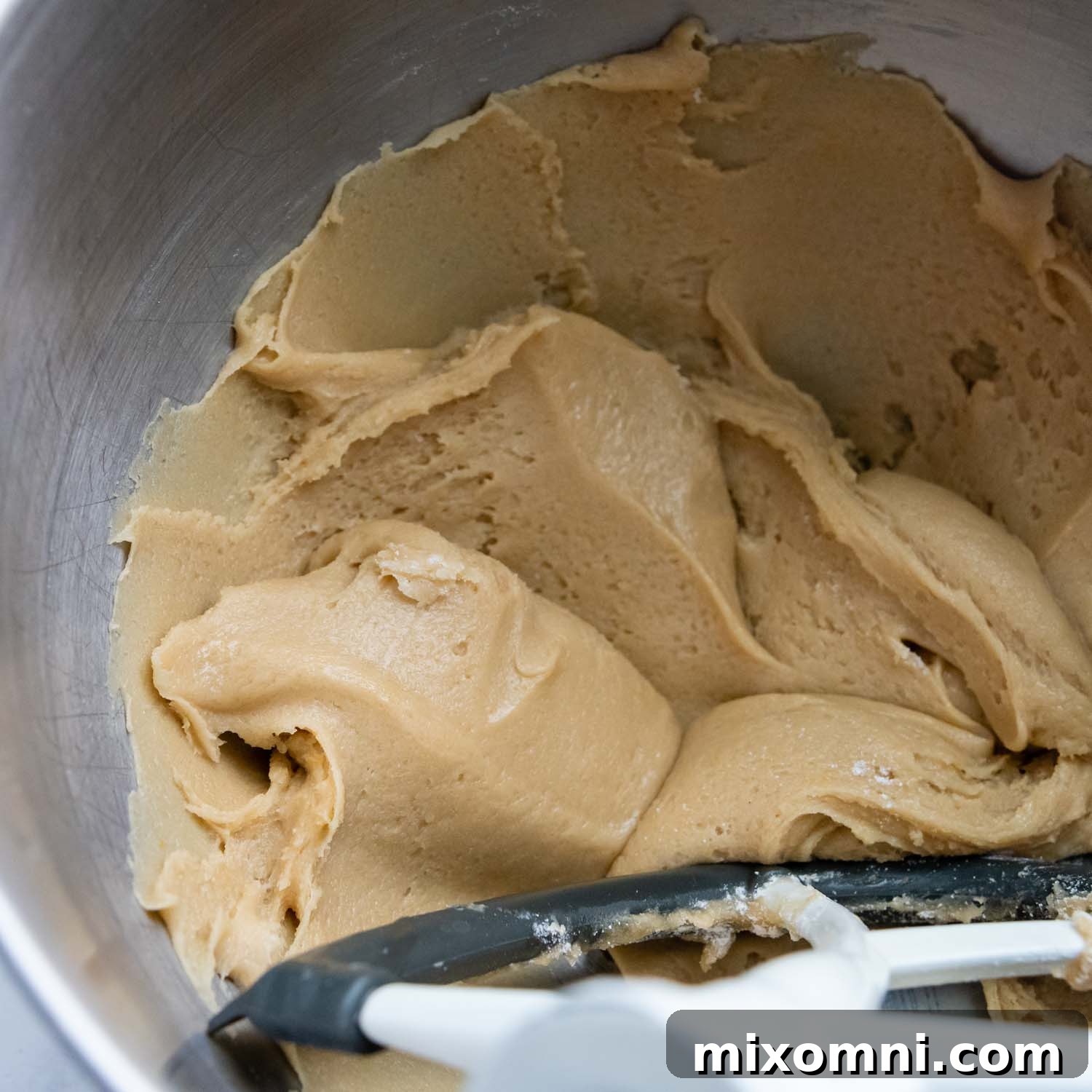 Cookie dough mixed together in a bowl, showing its soft, pliable consistency.