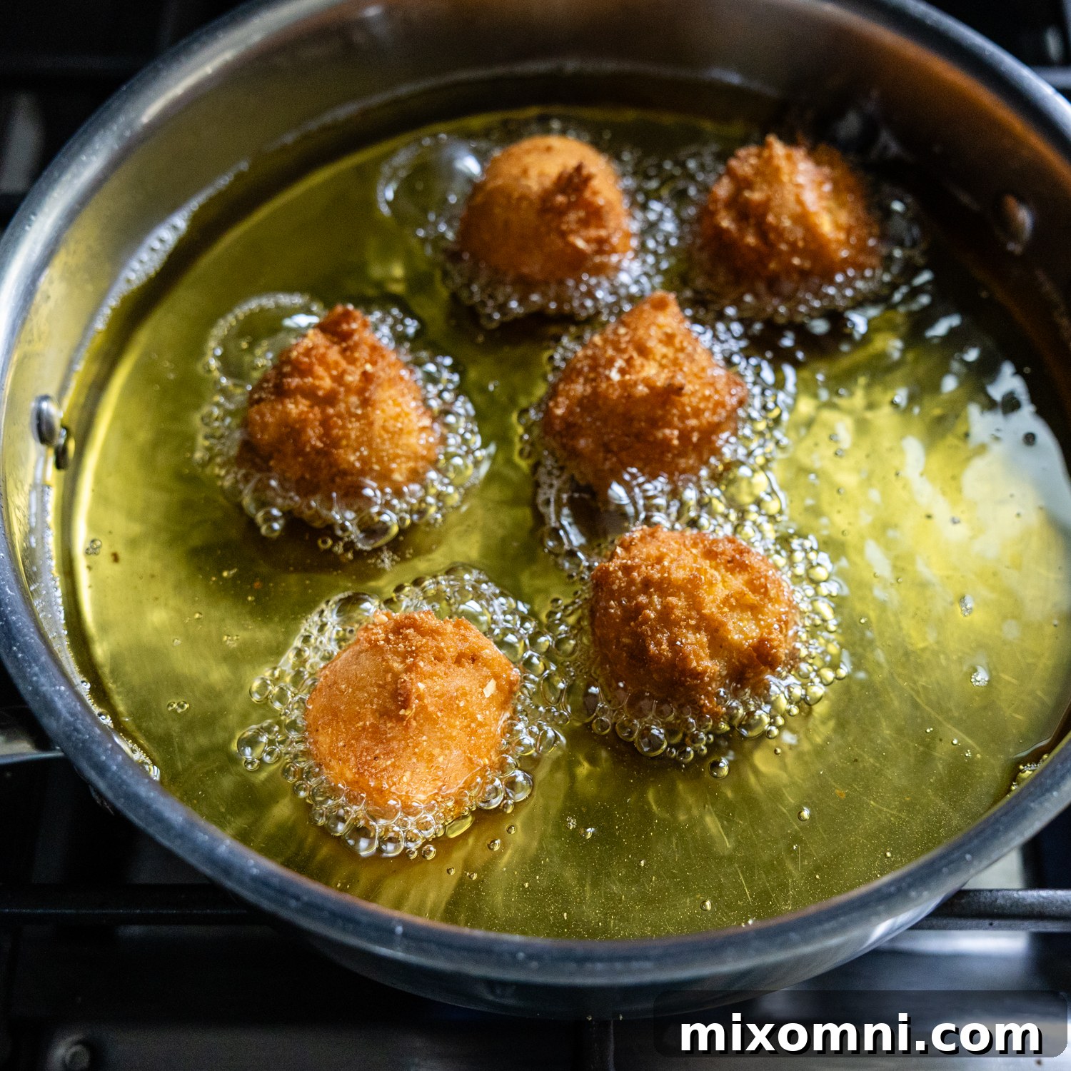 Hush puppy balls being fried.