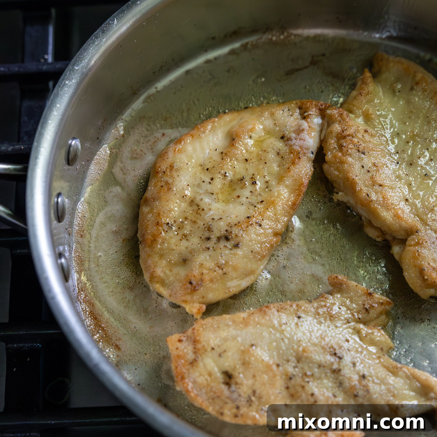 Chicken cutlets being fried.