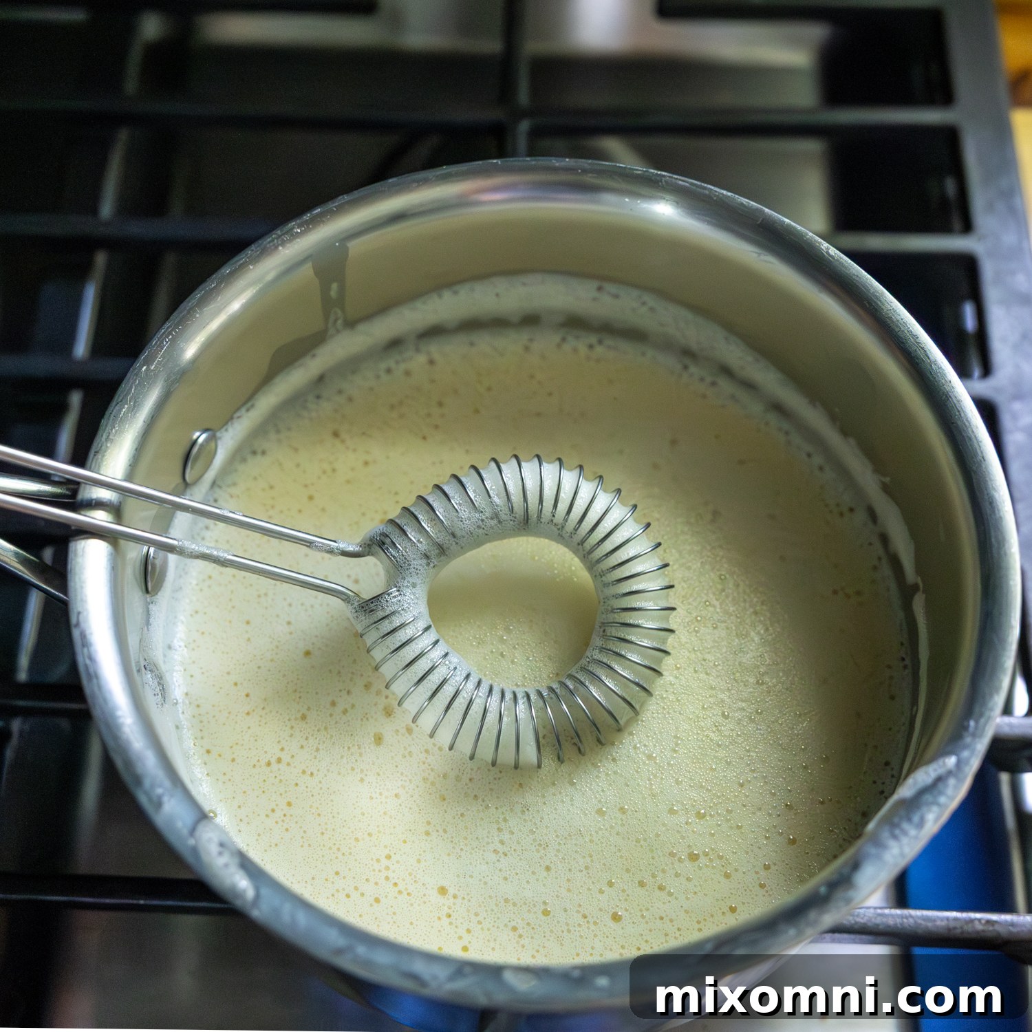 Mixture in sauce pan with whisk.