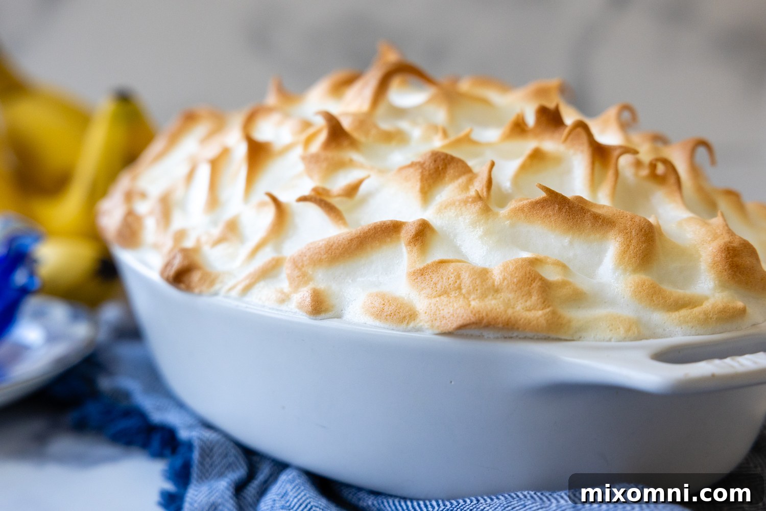 Cooked peaks of the banana pudding topping in a baking dish.