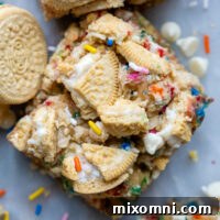 overhead shot of funfetti bars with crushed Oreos on top and a couple Golden Oreos laying next to it.